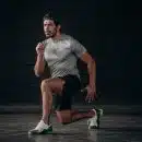 man in white crew neck t-shirt and black shorts sitting on floor