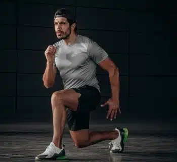 man in white crew neck t-shirt and black shorts sitting on floor